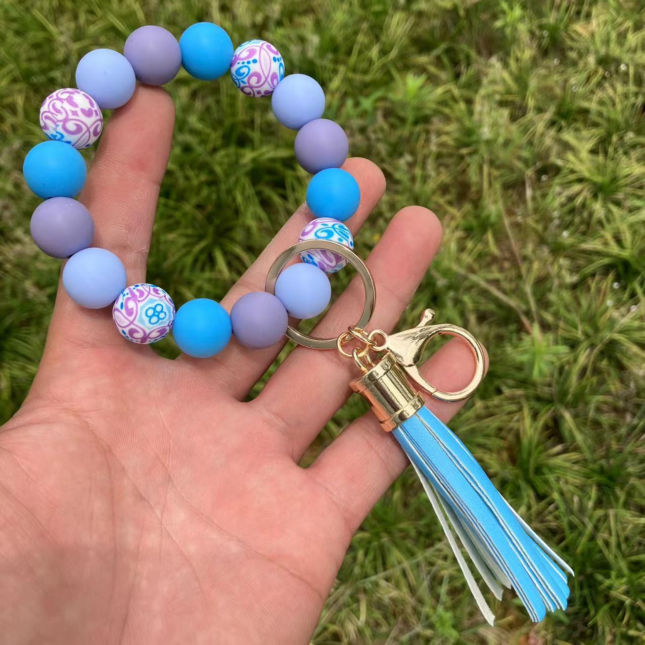 Comercio al por mayor leopardo girasol borla de silicona con cuentas llavero de muñeca